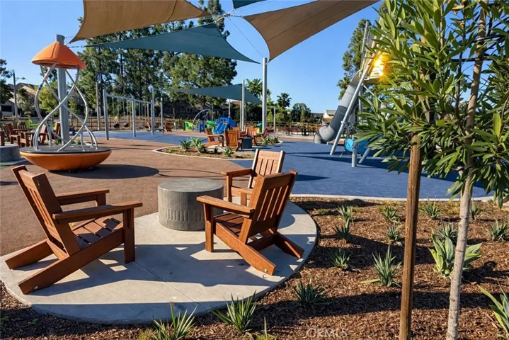 Modern playground, shaded seating, walking paths, and soft, cushioned safety surfacing.