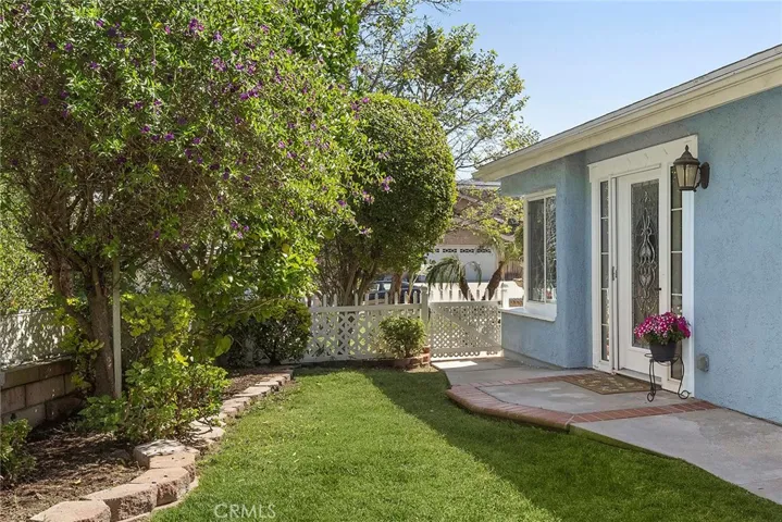 Beautiful front door with decorative glass and sidelights that let in natural light while still giving you privacy. As you walk up, you’ll notice the roses in bloom and an amazing lemon tree right out front.