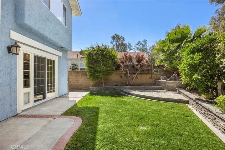 Private backyard with a spacious patio, lush lawn, and mature landscaping—offering a great balance of open space and a peaceful setting to relax or entertain. And yes, there’s a doggy door, so your fur baby can come and go with ease.