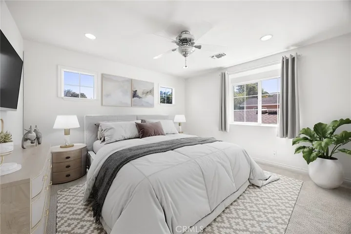 Bright, comfortable bedroom—considered the 4th bedroom and part of the add-on. Ceiling fan, recessed lighting and great natural light. Virtually staged to showcase its full potential.