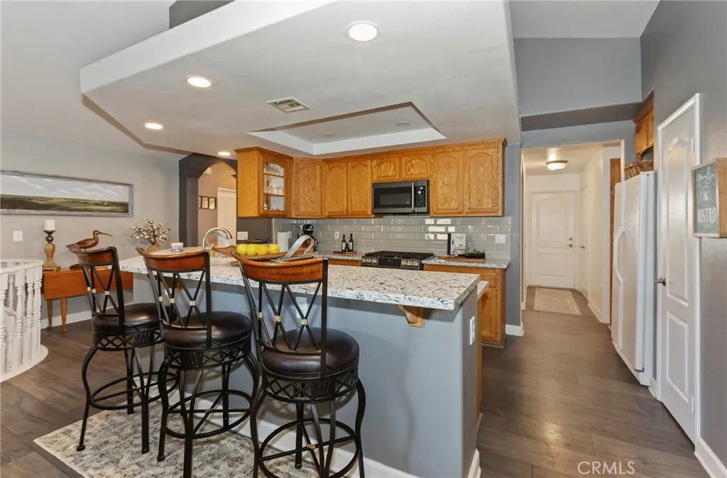 Beautiful upgraded kitchen with bar for dining.