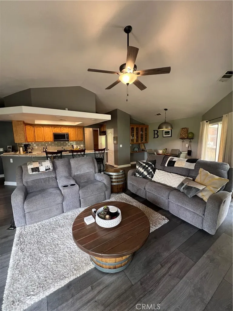 Main floor family room with ceiling fan and fireplace.