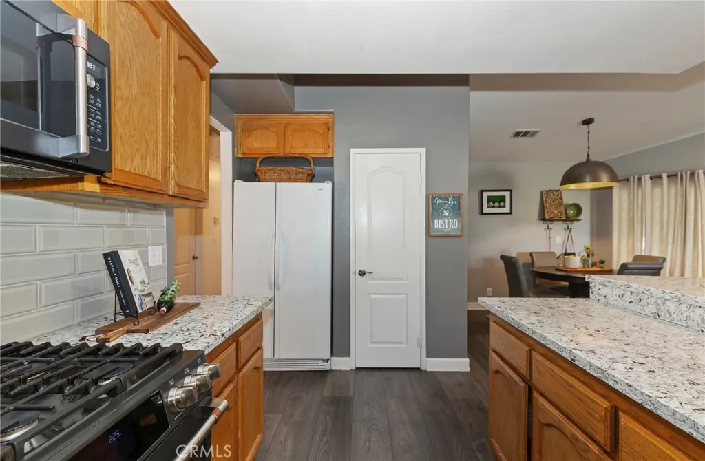 Nicely appointed kitchen with Quartz countertops and large gas range. Pantry makes for accessible storage.
