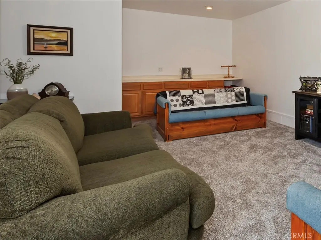 Lower level family room, lots of cabinets and carpeted.