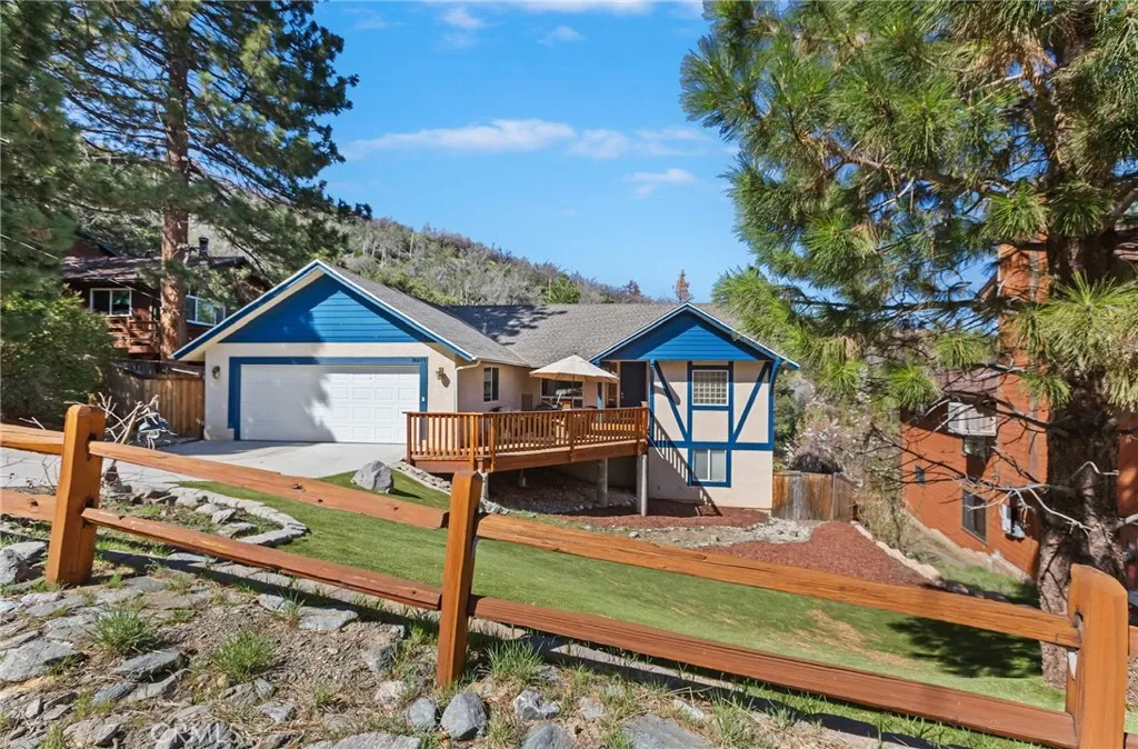 Large front yard with easy to maintain artificial turf.