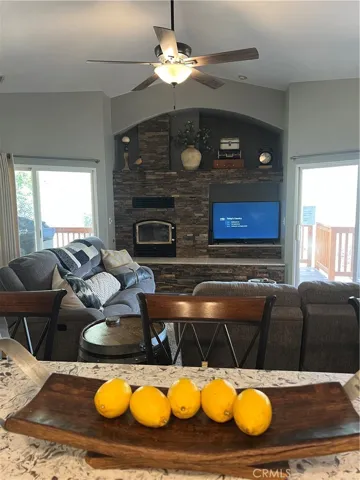 Fireplace with large hearth and TV nook.  Shelves above for lovely decor.