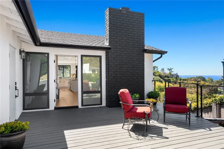 This open-concept home, upgraded in 2024, provides the perfect backdrop for coastal living, starting with an inviting oversized ocean-view front deck that sets the tone.