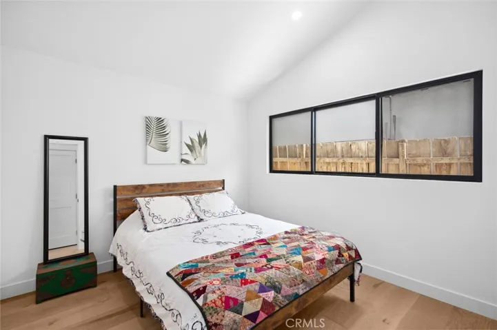 Two additional bedrooms and a bathroom, with a walk-in shower, provide comfort and flexibility for guests or family.