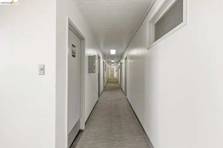 Hallway with light colored carpet