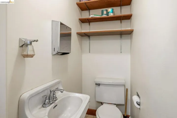 Half bath featuring toilet and a sink
