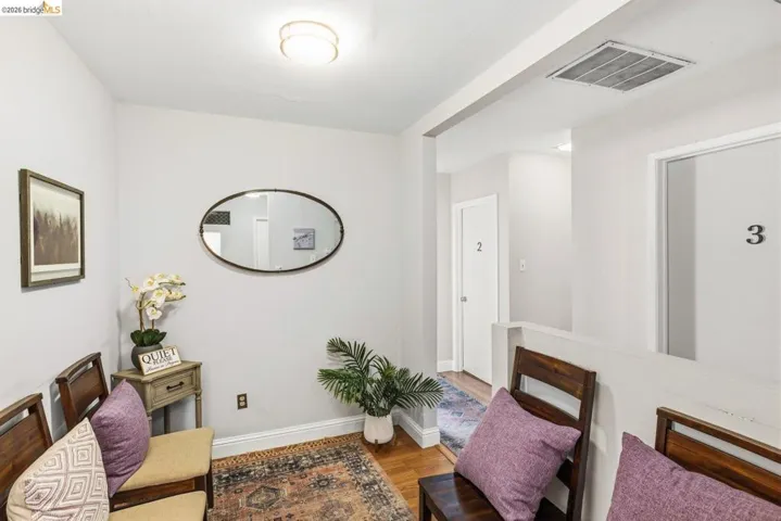 Living area featuring baseboards and light wood-type flooring