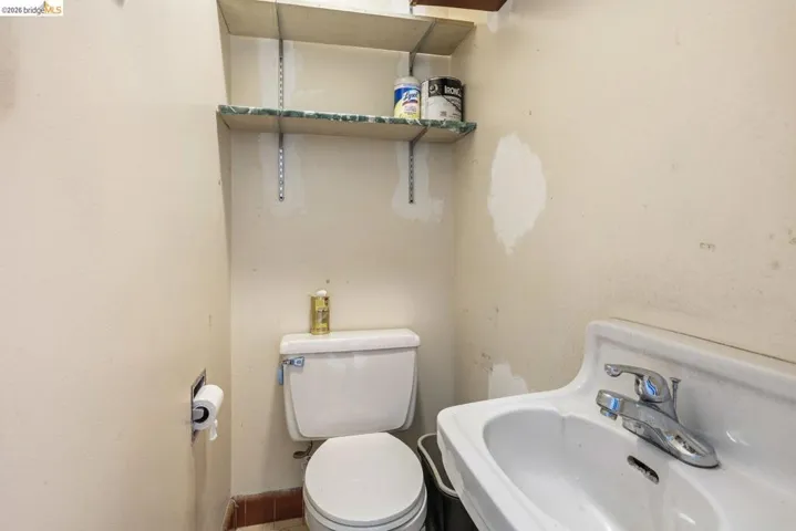 Half bathroom with toilet and a sink