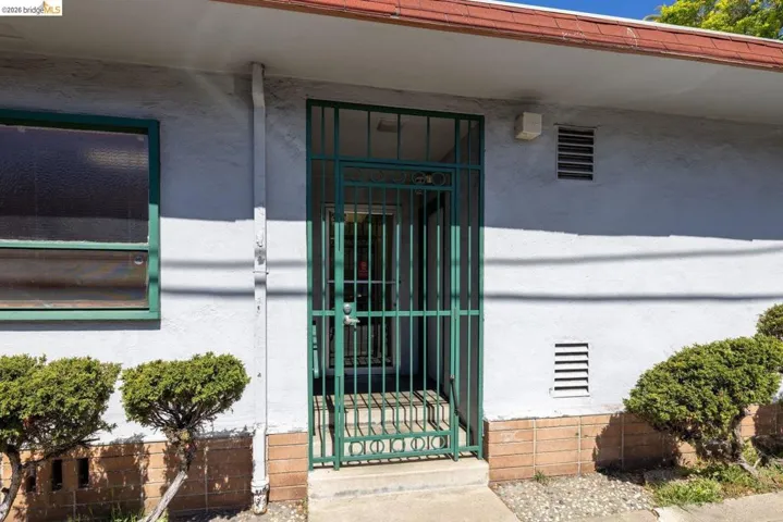 View of exterior entry featuring stucco siding