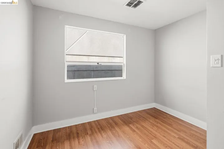Unfurnished room featuring light wood-style flooring and baseboards