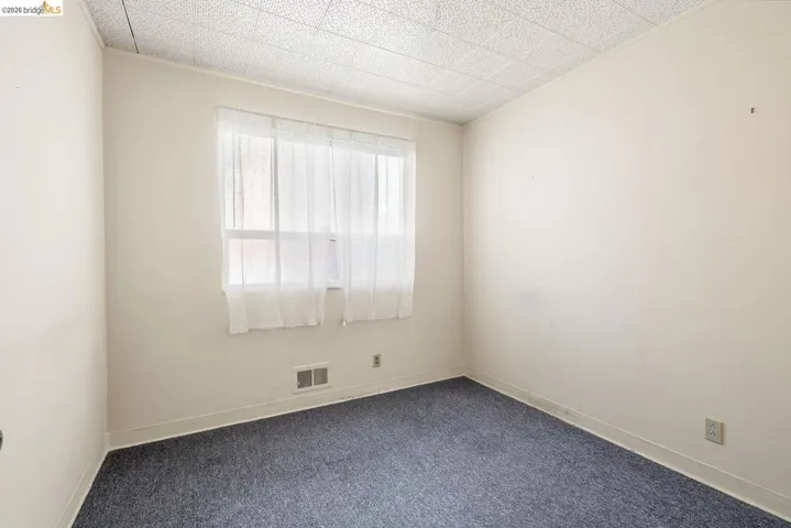 Unfurnished room with carpet floors and baseboards