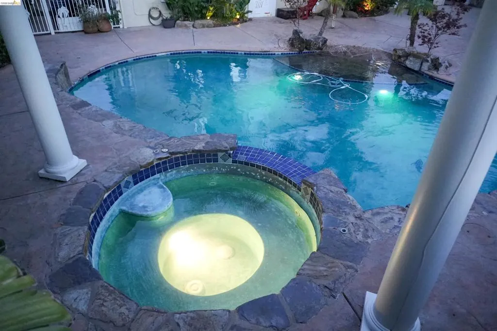 Relaxing pool / spa featuring a patio