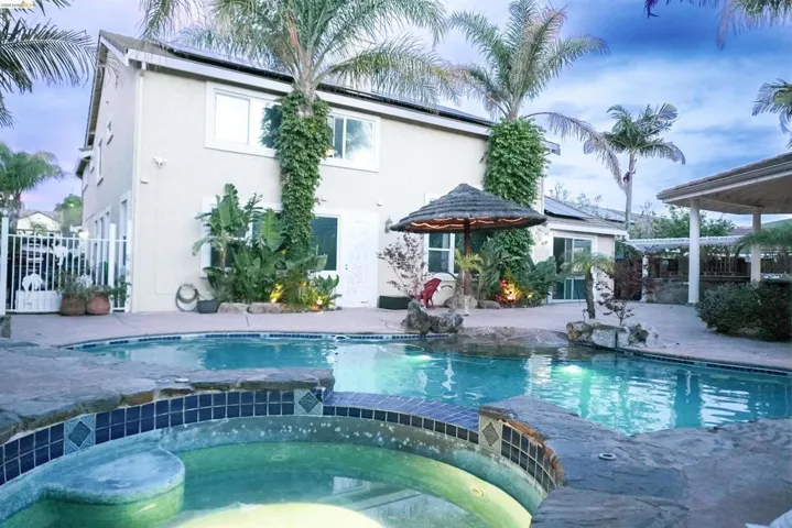 Combined pool / hot tub featuring a patio