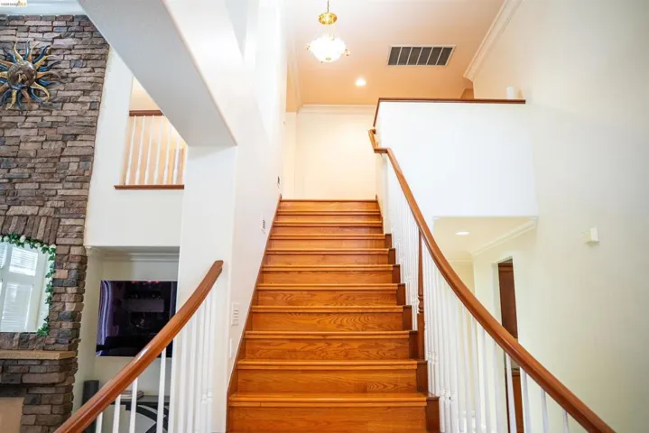 Stairs featuring ornamental molding and recessed lighting