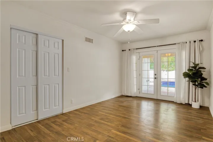 First bedroom on the right as you enter the hallway with a pool view