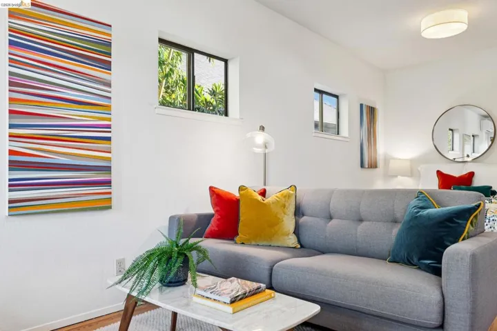 Living area with baseboards and wood finished floors