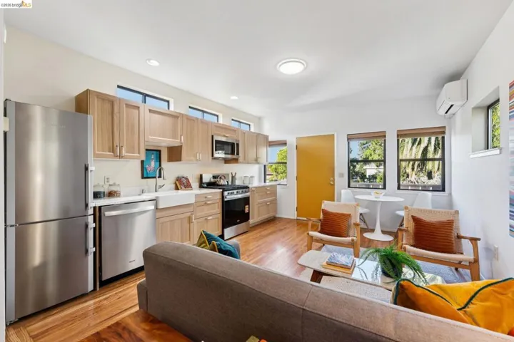 Kitchen with stainless steel appliances, light wood-style floors, healthy amount of natural light, and recessed lighting