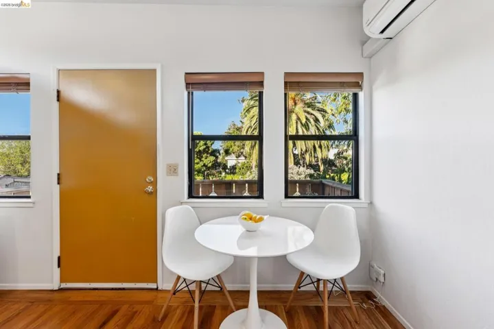 Dining room featuring a wall mounted mini split and wood finished floors