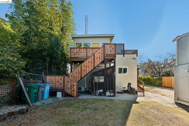 Back of house featuring a patio, a deck, and stucco siding