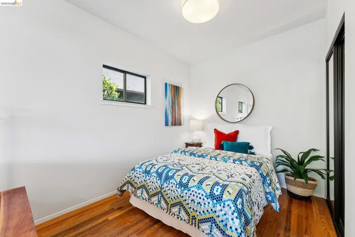 Bedroom with dark wood-style flooring
