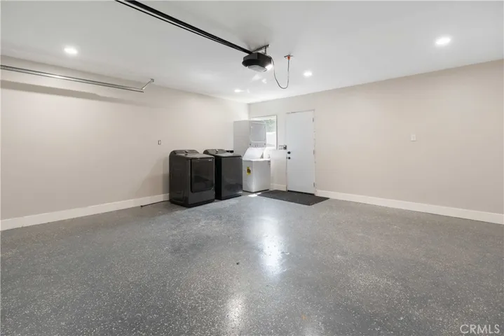 Laundry in Garage with Drywalled and Epoxy Coated Finished Floor