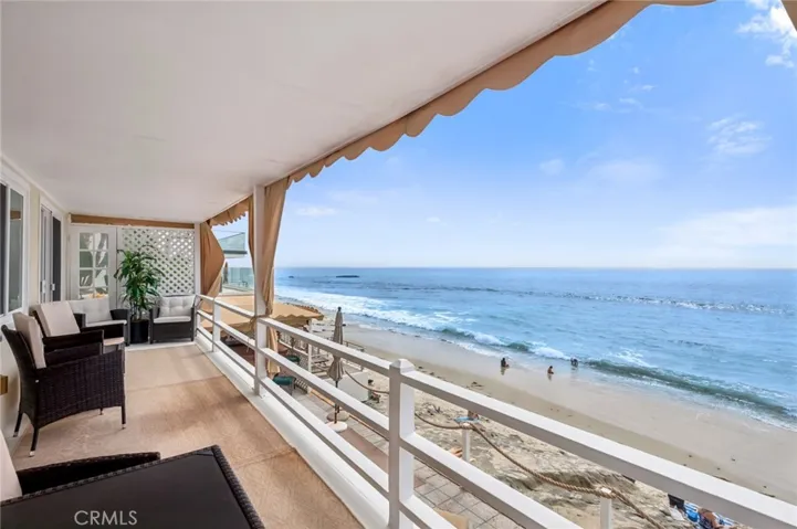 A private deck extends from both the living room and bedroom showcasing an idyllic setting for morning coffee accompanied by the soothing rhythm of the waves or relaxed evenings overlooking the horizon.