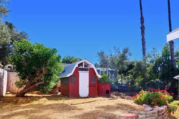 Cute barn shed (former chicken coop) houses the laundry room for both houses