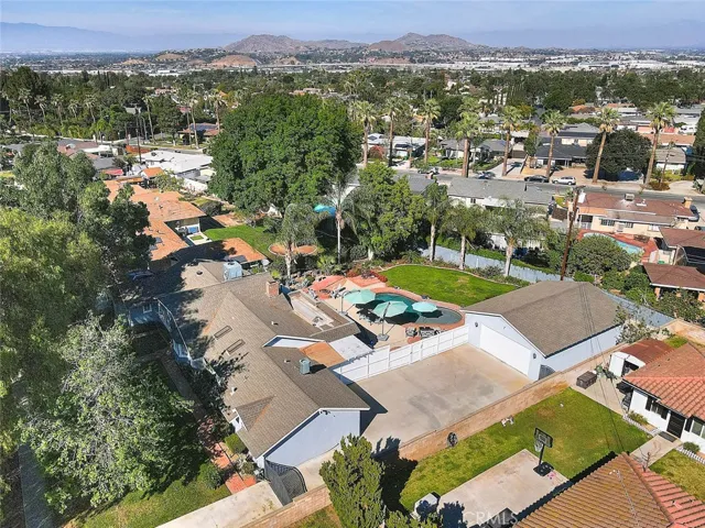 Driveway side view of home and backyard