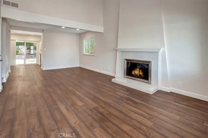 Living room, dining room, fireplace, cathedral ceiling