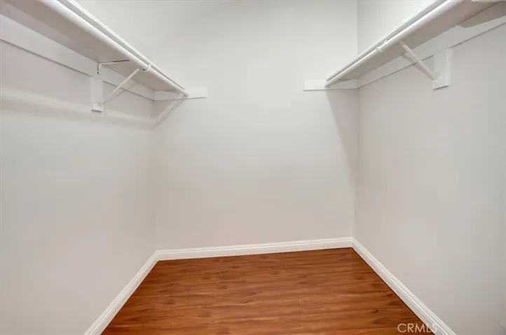 One of two walk-in closets (the other has organizers)