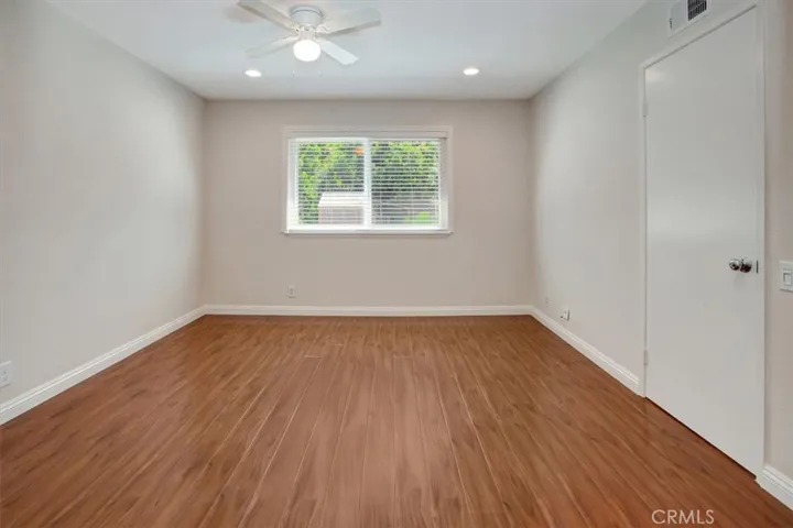 Primary bedroom with new ceiling fan, recessed lighting, freshly painted, new window