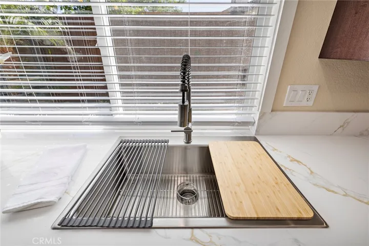 Sink with cutting board and drying rack