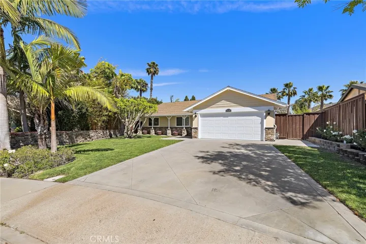 Front of home with long driveway on a pie shaped lot