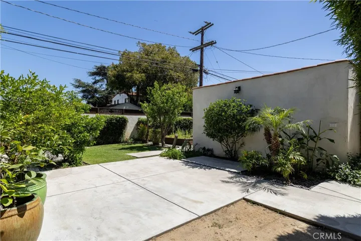 backyard patio space, view towards garage wall