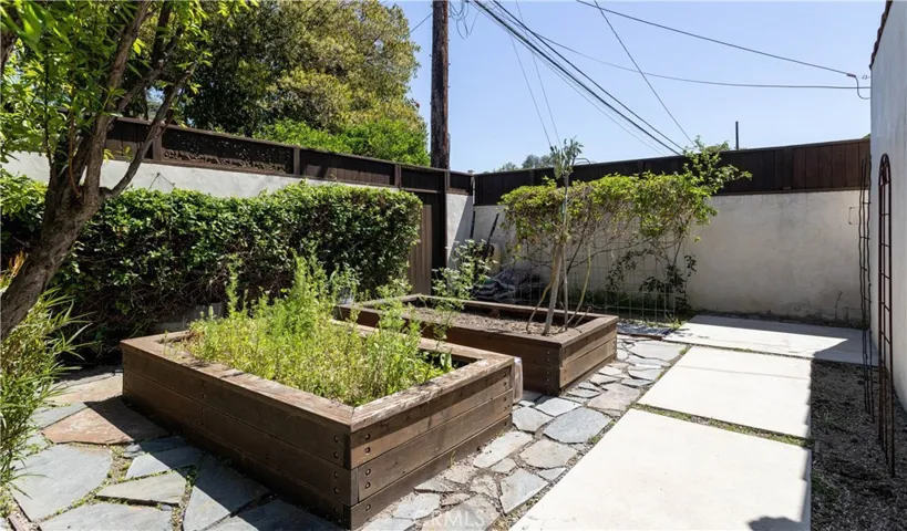 backyard raised vegetable beds behind garage