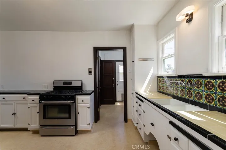 kitchen, view towards laundry room and back door to backyard and garage