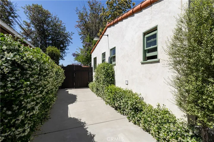Long driveway lined with jasmine, secure private gate at front.