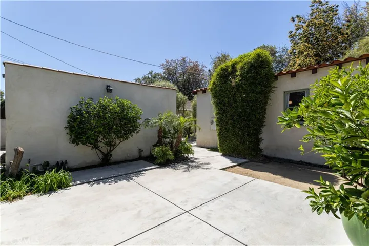 backyard patio space, view towards garage and back of house