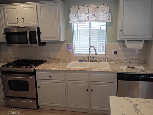 Kitchen with dual sinks and window view