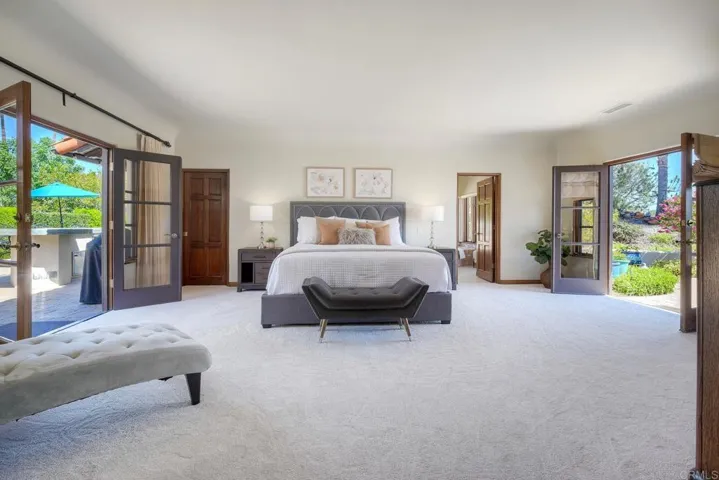 Spacious primary w/ dual French doors leading the outdoor living