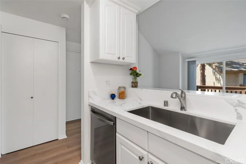 Brand new stacked washer and dryer in the closet off the kitchen