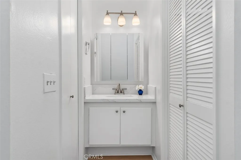 Newly remodeled vanity has quartz counter and new medicine cabinet and lighting.  Walk in closet to the left and newly remodeled bath to the right!