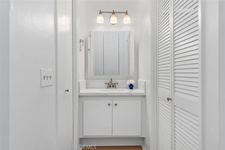 Newly remodeled vanity has quartz counter and new medicine cabinet and lighting.  Walk in closet to the left and newly remodeled bath to the right!
