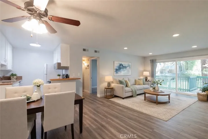 Living, Dining to Kitchen. Photo is virtually enhanced.