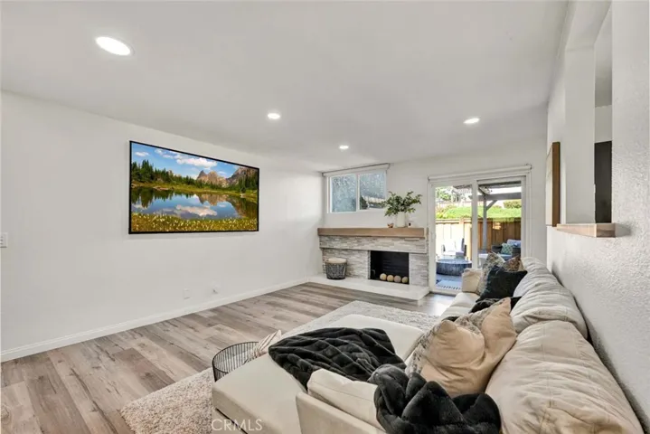 Remodeled fireplace in living room with recessed lighting