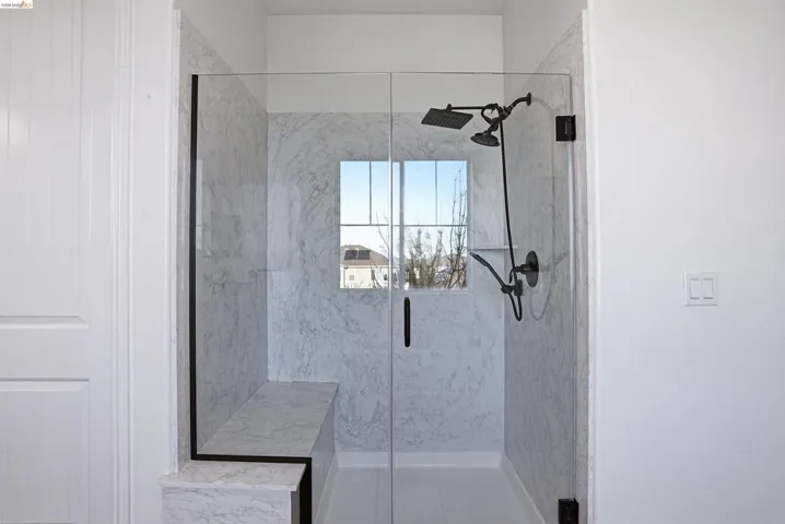 Bathroom with a marble finish shower